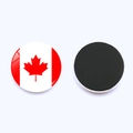 Macro detail of round Canada flag magnetic fridge sticker showing red maple leaf design - Canada Flag (PSXL00235-10)