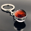 Close-up of Mars planet glass sphere keychain with red rock texture and silver metal ring - Mars