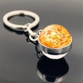 Close-up of galaxy-themed planet keychain with orange glass gem and silver metal ring - Sun (PSXL001134-7)