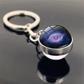 Macro shot of solar system nebula glass ball keychain reflecting on a black surface - Blue-Purple Nebula (PSXL001135-10)