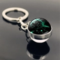 Detailed close-up of Sagittarius zodiac glass ball keychain with silver metal ring - Sagittarius