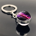 Macro view of the solar system galaxy nebula glass ball keychain on a dark mirror surface - Deep Galaxy (PSXL001135-12)