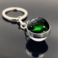 Detailed macro view of Aries zodiac sign double-sided glass ball keychain with silver ring - Aries