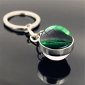 Macro view of double-sided glass orb keychain showing vivid green aurora borealis patterns - Aurora Style 10 (PSXL001176-10)