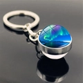 Detailed close-up of double-sided Aurora glass ball keychain with silver metal base and reflections - Aurora Style 11 (PSXL001176-11)