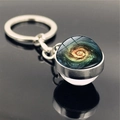 Detailed close-up of a double-sided glass galaxy pendant keychain with a blue spiral nebula - Bright Colorful Spiral Galaxy Style (PSXL001466-5)