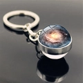 Close-up of glass ball keychain featuring a cosmic space vortex and nebula galaxy pattern - Blue-Yellow Intertwined Nebula Style (PSXL001466-7)