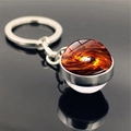 Macro detail of universe galaxy keychain showing glowing orange nebula in a glass sphere - Orange-Red Vortex Nebula Style (PSXL001466-11)