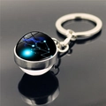 Macro shot of Taurus constellation glass sphere keychain with silver metal base and starry sky - Taurus (XSWX2268-9)