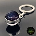 Detailed close-up of Gemini zodiac luminous crystal ball keychain with metallic ring - Gemini (XSWX3751-5)