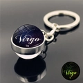 Detailed macro view of Virgo constellation luminous glass ball keychain with silver metal base - Virgo (XSWX3751-12)