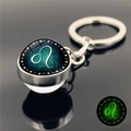 Porte-clés signe Lion phosphorescent avec boule de verre et anneau en métal argenté - Lion