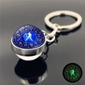 Luminous Libra constellation keychain featuring a green glow-in-the-dark glass ball pendant - Libra