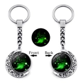 Luminous Aries zodiac keychain with rotating double-sided moon and green starlight glass orb - Aries