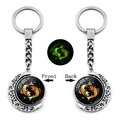 Luminous Pisces zodiac keychain featuring double-sided rotating moon pendant and green glow - Pisces