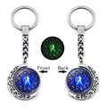 Detailed view of rotating Libra zodiac moon keychain with luminous effect in dark - Libra