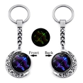 Detailed view of luminous Sagittarius zodiac moon keychain with rotating double-sided pendant - Sagittarius
