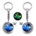 Porte-clés Capricorne phosphorescent avec pendentif lune rotatif en métal argenté - Capricorne