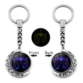 Detailed view of luminous Libra constellation spinning moon pendant on silver keychain - Libra