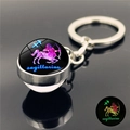 Portachiavi con sfera di vetro Sagittario luminoso e segno zodiacale in cornice metallica - Sagittario