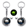 Close-up of rotating Taurus zodiac keychain with luminous moon pendant and silver finish - Taurus