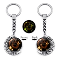 Double-sided rotating Leo zodiac keychain with silver crescent moon and glowing effect - Leo