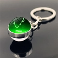 Double-sided glass ball keychain with luminous green Pisces zodiac sign constellation - Pisces