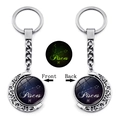 Detailed macro view of rotating Pisces constellation keychain with glowing moon charm - Pisces (XSWX4669-8)