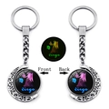 Glow-in-the-dark Virgo zodiac keyring featuring a rotating moon pendant and silver frame - Virgo