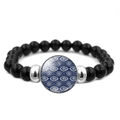 Dettaglio del bracciale con perline nere, ciondolo Evil Eye blu e distanziatori argentati - Occhio di Vetro Blu 6 (XSWX4710-6)