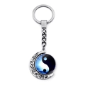 Macro shot of silver crescent moon keychain with rotating yin yang pendant and blue gradient - Xswx4434-5