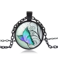 Detail of a vintage black butterfly pendant necklace with a glass dome and colorful artwork - Black Style 3