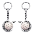 Front and back views of a 360-degree rotating silver volleyball moon keychain charm - Volleyball Pattern (XSWX5266-6)