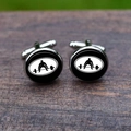 Macro detail of silver weightlifting cufflinks featuring a black athlete silhouette on wood - Weightlifter Pattern (5HXK0100-8)