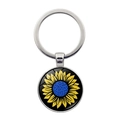 Dettaglio del portachiavi rotondo in metallo con ciondolo a girasole su sfondo bianco - Girasole Singolo Base Nera (XSWX5352-4) / Argento