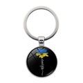Detailed macro view of Ukraine sunflower charm with silver metal key ring and keyring - Silver