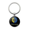 Detailed view of round glass keychain featuring Ukraine sunflower design and trident emblem - Coat of Arms Sunflower Text (XSWX5352-11) / Silver