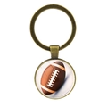 Porte-clés de football américain en bronze avec pendentif en verre sur fond blanc - Football Américain - Bronze Antique