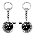 Silver crescent moon spinning keychain with black round pendant featuring letter N - Initial N Style (XSWX5286-N)