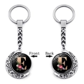 Detail view of double-sided rotating crescent moon keychain with floral letter E pendant - Initial E Floral Style (XSWX5492-E)