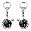 Close-up of double-sided rotating moon keychain featuring floral letter G pendant - Initial G Floral Style (XSWX5492-G)