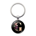 Detailed macro view of silver keychain with letter G and purple floral motif charm - Letter G (XSWX5495-G)