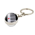 Macro detail of piano keys pendant with a red heart on polished silver metal keychain - Heart Keyboard Red White Style (XSWX5700-9)