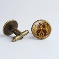 Dettaglio di gemelli in bronzo vintage con motivo fenice dorata sotto cupola di vetro - Bronzo Antico