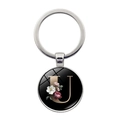 Silver metal keychain featuring a glass dome with a floral gold letter U on black - Letter U (XSWX5495-U)
