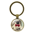 Close-up of bronze metal keychain featuring a cute pug dog with a red bow tie design - Pug with Red Bowtie (XSWX5758-4 Antique Bronze)