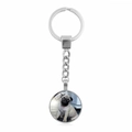 Macro view of a polished silver metal keychain featuring a cute Pug dog glass pendant - Charming Pug Face Close-Up (XSWX5756-7)