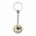 Close-up of a silver keychain with a round pug dog illustration under glass dome pendant - Realistic Illustration Pug (XSWX5756-5)