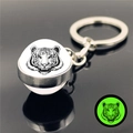Detailed view of tiger head glass ball keychain with green glowing effect in the dark - Black and White Realistic Tiger Head (XSWX5837-9)