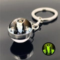 Luminous silver keychain with glass dome featuring Jesus and green glow in the dark effect - Ascension of Jesus (XSWX2486-13)